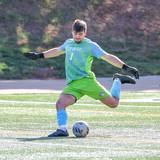 Zach Weis kicks a soccer ball during a NWU soccer game. 